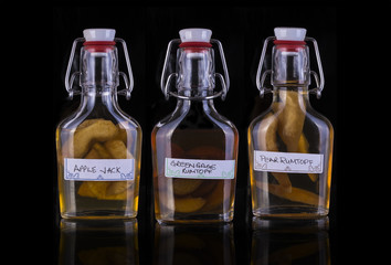 Home made Rumtopf and Apple Jack  on a black background