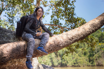 Asian woman backpack taking a photo with mirrorless camera