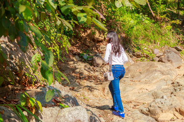 Woman hiking around mountains near the river at spring time.