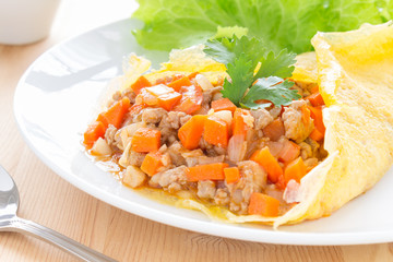 Stuffed Omelet With Carrot Onion Pork Lettuce in White Dish on Wood Table