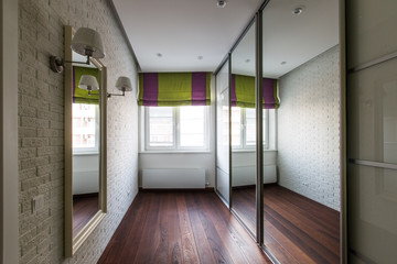 The design of a long light corridor, in which there are many mirrors