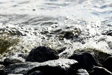 Coastal rocks on wave background