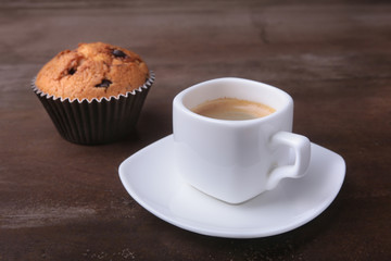Homemade muffin with raisins and cup classic espresso coffee. selective focus.