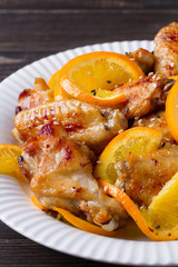 Orange chicken wings with sesame seeds, vertical