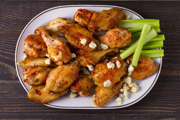 Chicken wings buffalo with blue cheese and celery sticks. View from above, top, horizontal