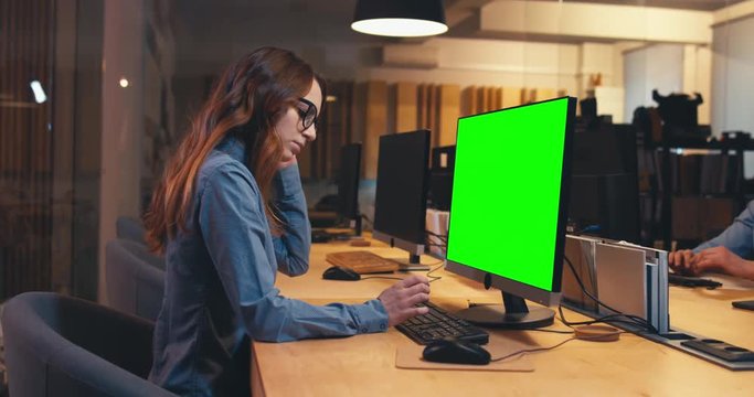 Man and woman colleagues professionals communicating while working together in modern office. Green screen chroma key. 4K UHD