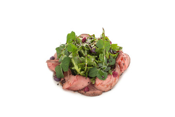 A beautiful salad of meat, greens and balsamic vinegar on an isolated background