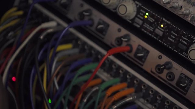 Recording studio, the wires connected to music splitter console, close-up.
