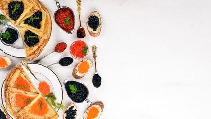 Pancakes with caviar. On a wooden background. Top view. Free space for text.