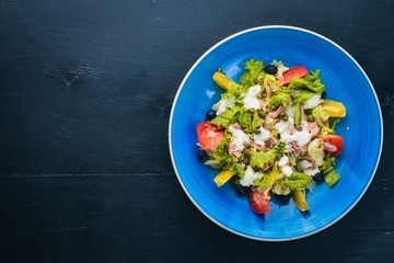Vegetable salad and mozzarella, tuna and capers. Italian cuisine. Free space for your text. Top view.