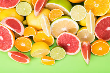 summer juicy mix of citrus fruits on a bright green board