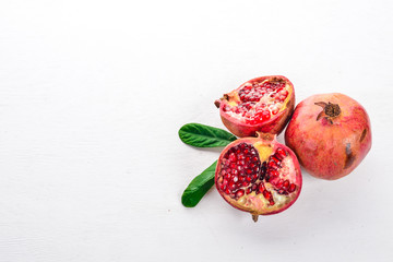 Pomegranate. Fresh fruits. On a wooden background. Top view. Free space for text.