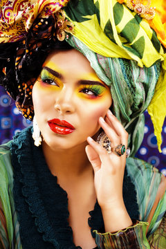 beauty bright woman with creative make up, many shawls on head like cubian