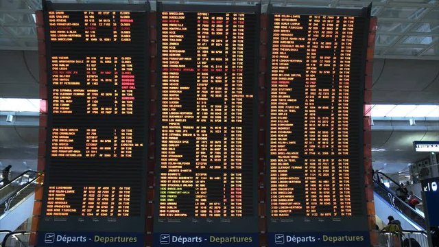 the flight departure board at an airport in paris