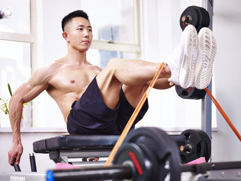 asian bodybuilder exercising in gym