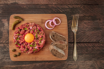 Closeup of steak tartare with garnish, and copyspace