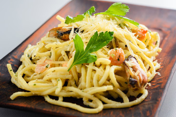 pasta with mussels and prawns in creamy sauce. Traditional Italian cuisine, pasta with seafood