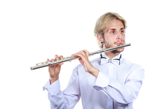Male flutist playing his flute