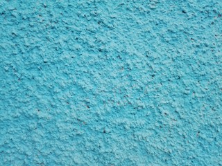 Сoncrete of a blue plastered wall. Sky blue plastered wall texture grunge background. Beautiful decorative light blue plastered wall or cyan painted stucco. Handmade rough winter christmas paper.