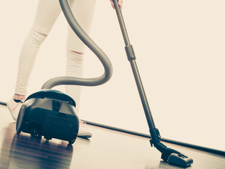 Woman legs and vacuum cleaner