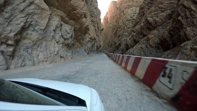 POV Driving through Todra Gorge gap in Morocco desert landscape &ndash; steadyshot in 4K