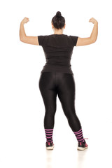 Back view of chubby woman in fitness clothing on white background