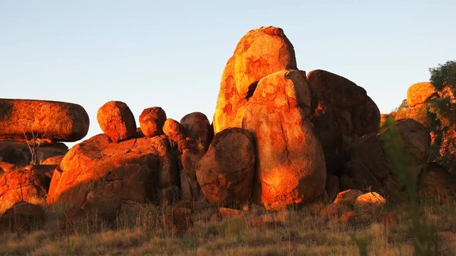 a panning shot of the devil's marbles in australia's northern territory at sunset