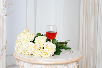 Romantic holiday composition with wine glass and roses for Valentines Day. Love, gift and spring holiday background.