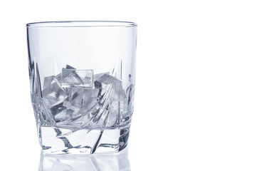 Glass with ice cubes closeup isolated on white background