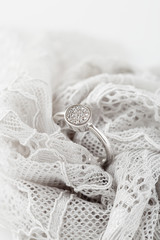 Obraz premium Wedding or engagement silver ring on lace