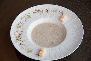  plate of mushroom soup on wood plate