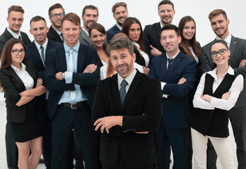 confident businessman standing on background of her business team.