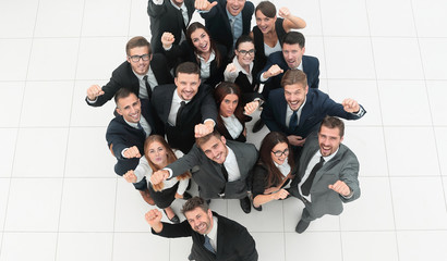 concept of success. business team raising hands and looking at camera.