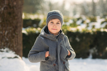 In perfect winter weather the boy poses to the photographer