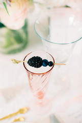 Pink wine glass with berries