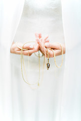 Woman's hands holding necklace