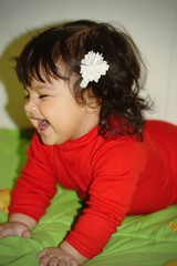 Obraz premium Baby girl with white flower smiling