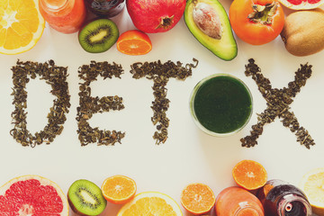 Healthy eating concept. Word 'detox' from green tea with colorful smoothies and fruits. Top view