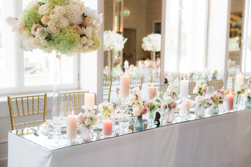 High vase floral center pieces on dining table