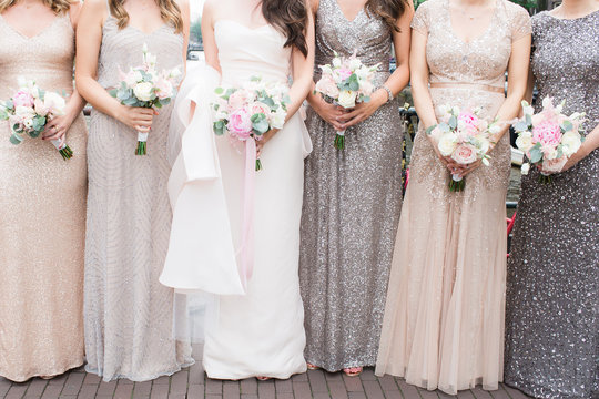 bride and bridesmaids holding pastel bouquets
