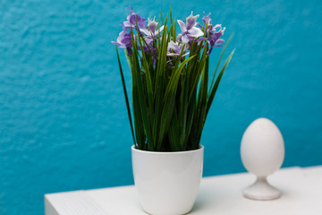 Easter egg on grass in a white ceramic flowerpot easter decorations