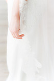bride's hand holding lace veil