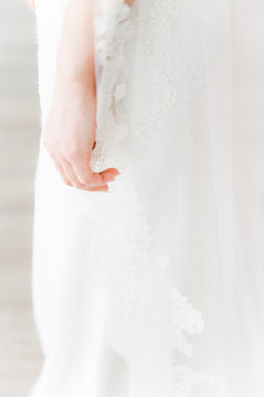 bride's hand holding lace veil
