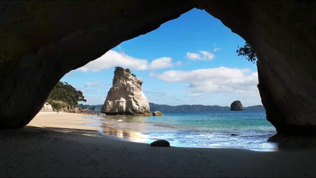 morning wide view from the rock arch at cathedral cove at hahei, new zealand
