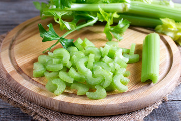 chopped green celery on a kitchen wooden board