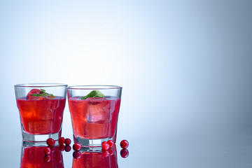 closeup of a cape cod cocktail or vodka cranberry on a blue background