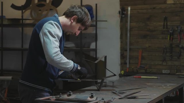 Blacksmith working with metal decorative detail at his workshop