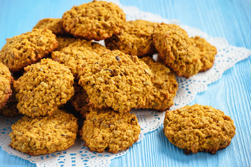 Soft pumpkin oatmeal cookies on blue wooden background.