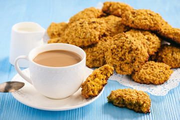 Soft pumpkin oatmeal cookies on blue wooden background.