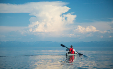 Fototapeta na wymiar Mеn kayaking on Lake Baikal. Landscape. Siberia.